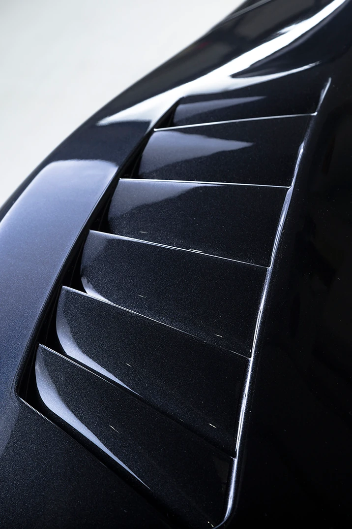 Vented carbon hood on a track-prepared car