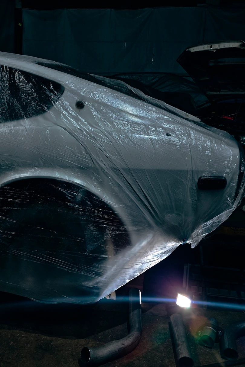 Classic car body covered and prepped in the shop
